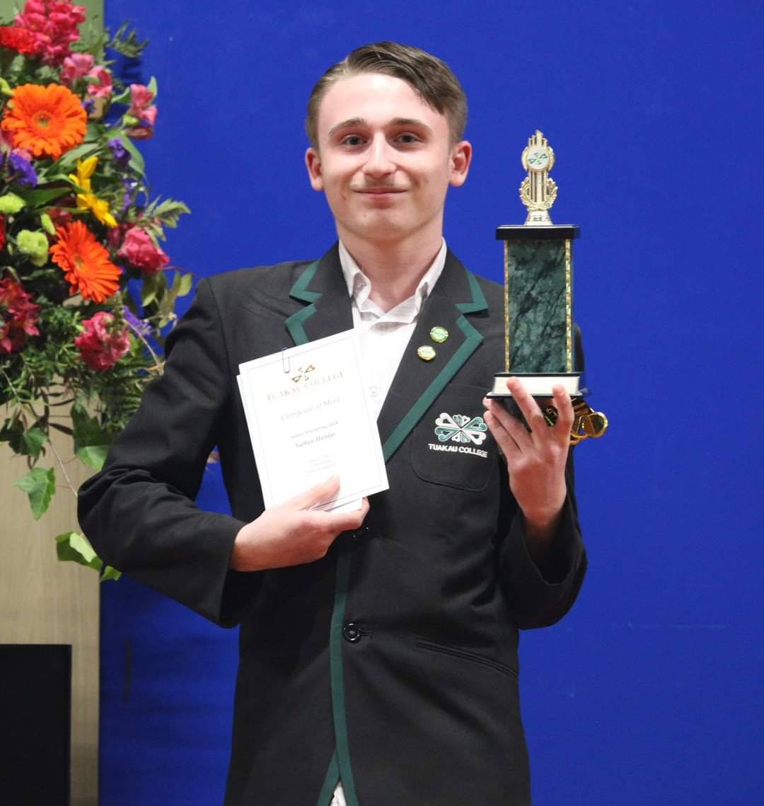 Nathan Haliday holding his top mathematician trophy at prizegiving